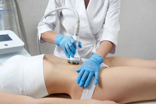 Lost the Weight but Not the Loose Skin? 2 woman having HIFU treatment on her stomach to combat loose skin Farnham following weight loss